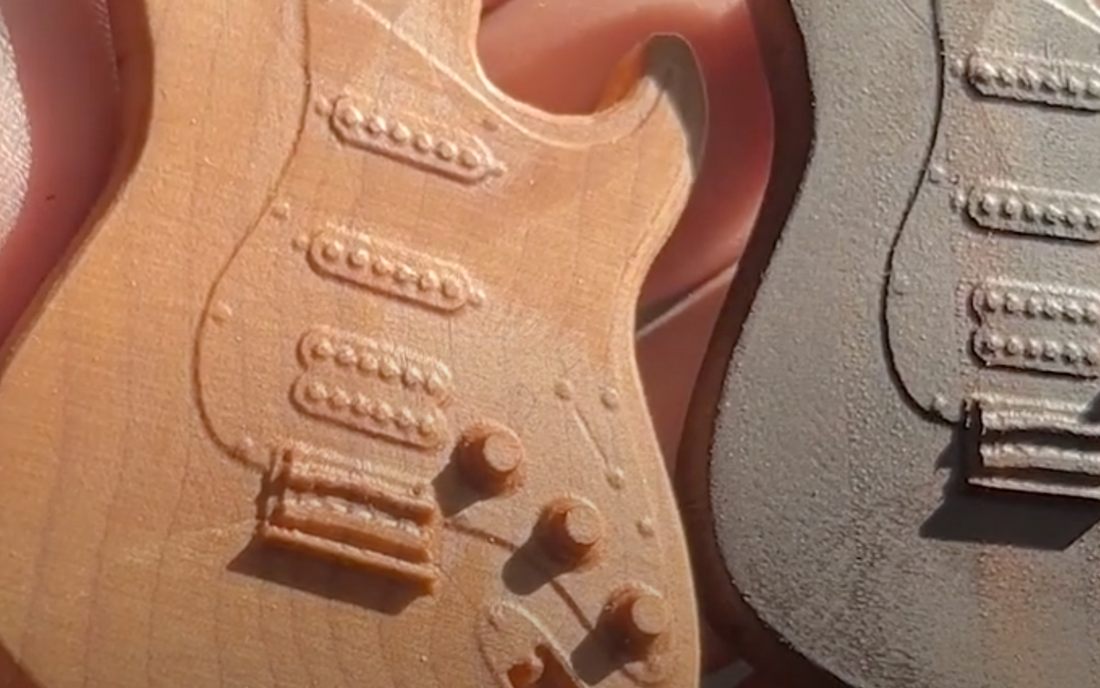 3D-printed guitar-shaped prototypes showcasing intricate design and precision, demonstrating the capabilities of advanced prototyping and material accuracy for iterative product development.