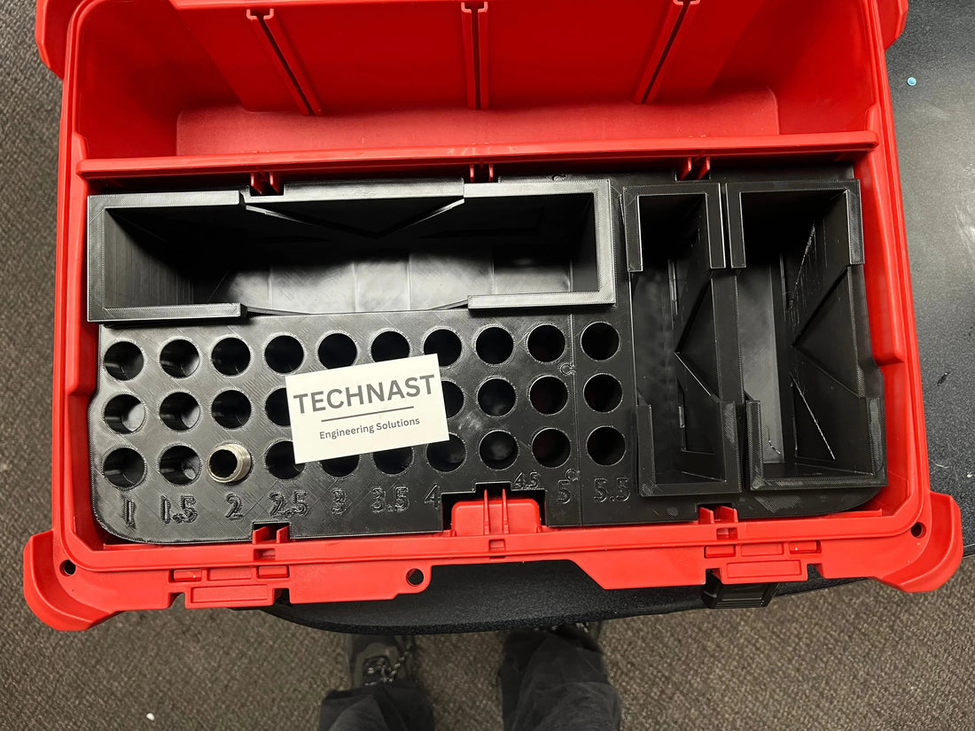Custom black 3D-printed organizer insert fitted inside a red toolbox, with labelled circular tool holders and TECHNAST Engineering Solutions card.