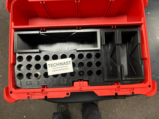 Custom black 3D-printed organizer insert fitted inside a red toolbox, with labelled circular tool holders and TECHNAST Engineering Solutions card.