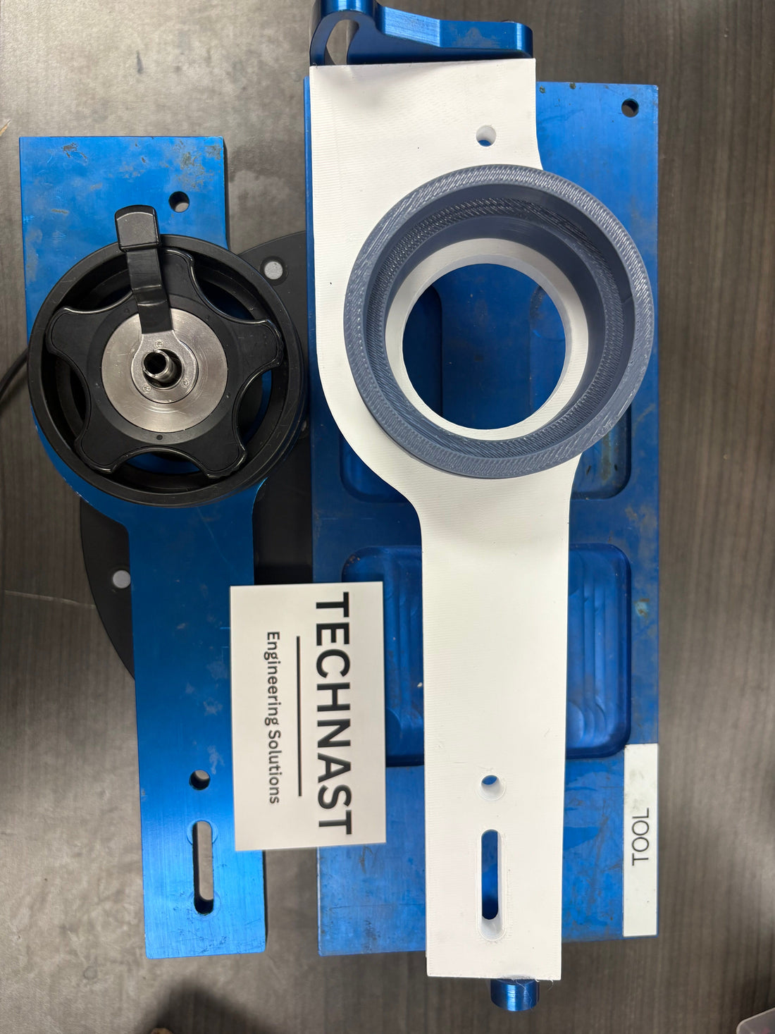 TECHNAST complementary 3D-printed service fixture alongside the existing blue metal base, from a documented endoscope repair-tooling project
