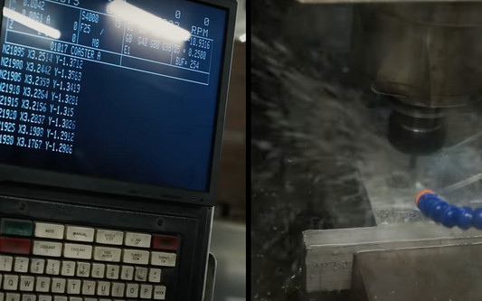 A CNC machine screen displaying G-code programming on the left, with the milling process in action on the right, showing a metal workpiece being machined under coolant spray.