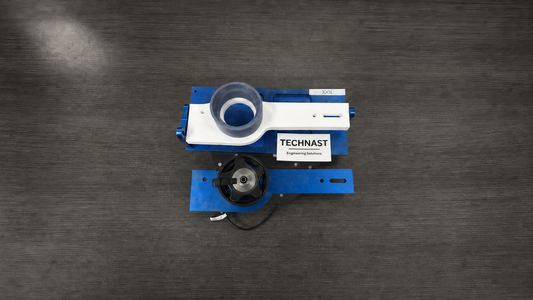 Original blue metal endoscope service fixture beside TECHNAST's complementary white and grey-blue 3D-printed fixture on a wide dark workbench